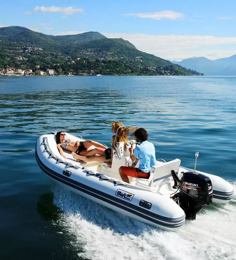 A group of people on a boat in the water.